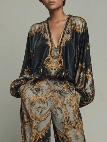 Statement women's two-piece set: vibrant baroque print V-neck top and comfortable wide-leg trousers outfit.
