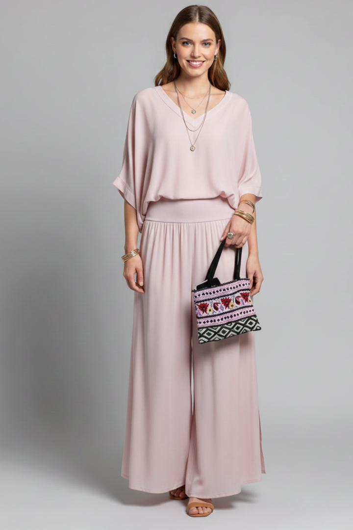 Women's occasion wear two-piece set featuring a flattering batwing top and elegant wide leg trousers.