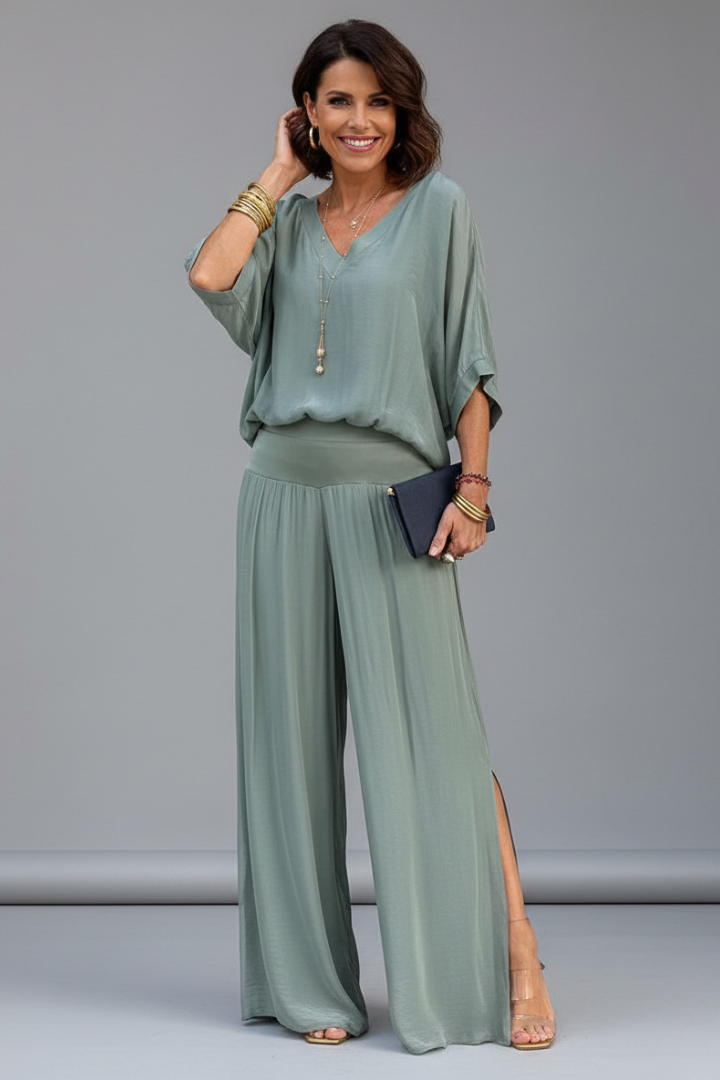 Sophisticated women's pant set: elegant batwing sleeve top paired with stylish wide leg pants. Occasion ready.