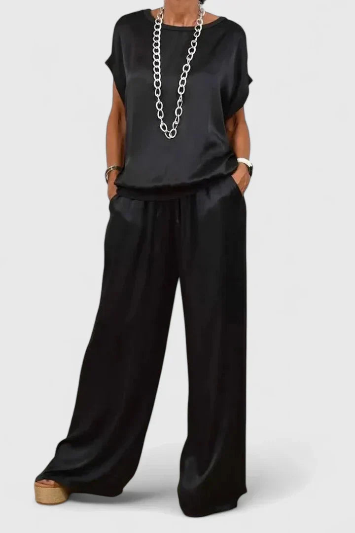 Women's elegant batwing top & wide leg trouser matching set in black, perfect for smart casual or loungewear comfort.