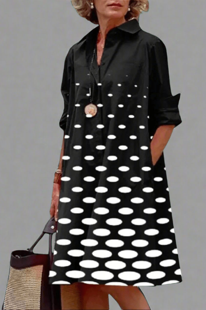 Women's elegant black polka dot button-up A-line midi shirt dress, perfect for smart casual style.