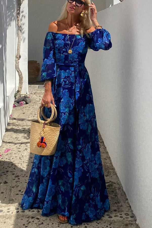 Flowy off-shoulder women's maxi dress with blue floral print, ideal for elegant evening wear or a chic summer party.