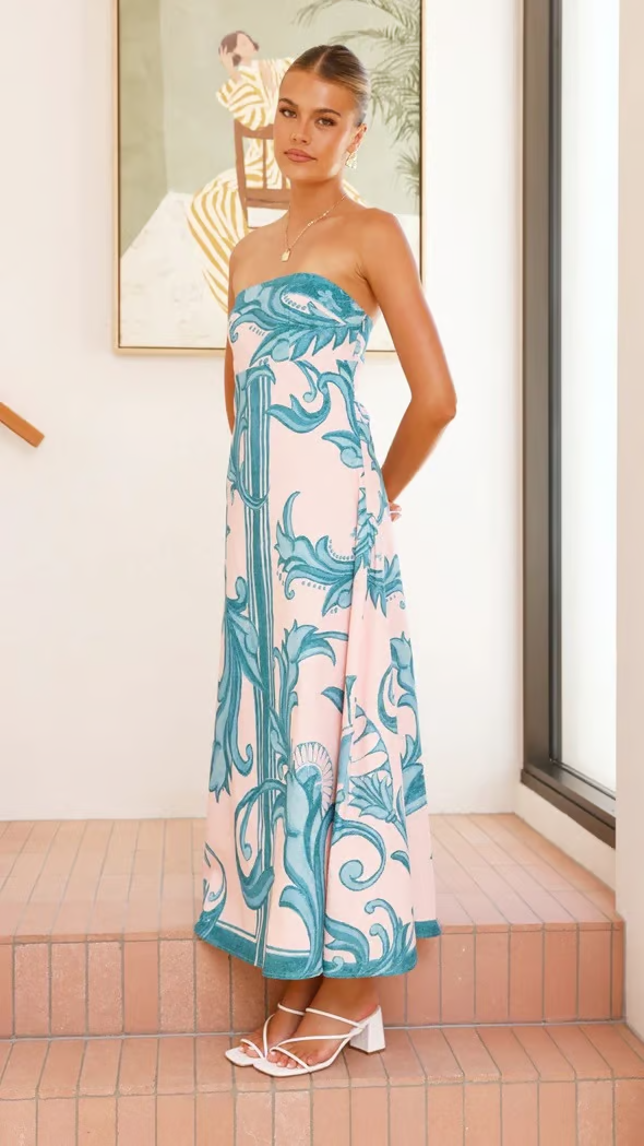 Model wearing a graceful blue printed flowy short sleeve midi dress, showcasing its elegant drape.