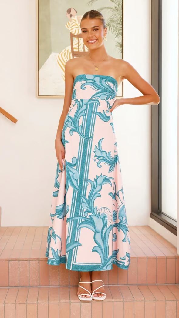 Back view of an elegant women's blue flowy printed short sleeve midi dress for stylish occasions.