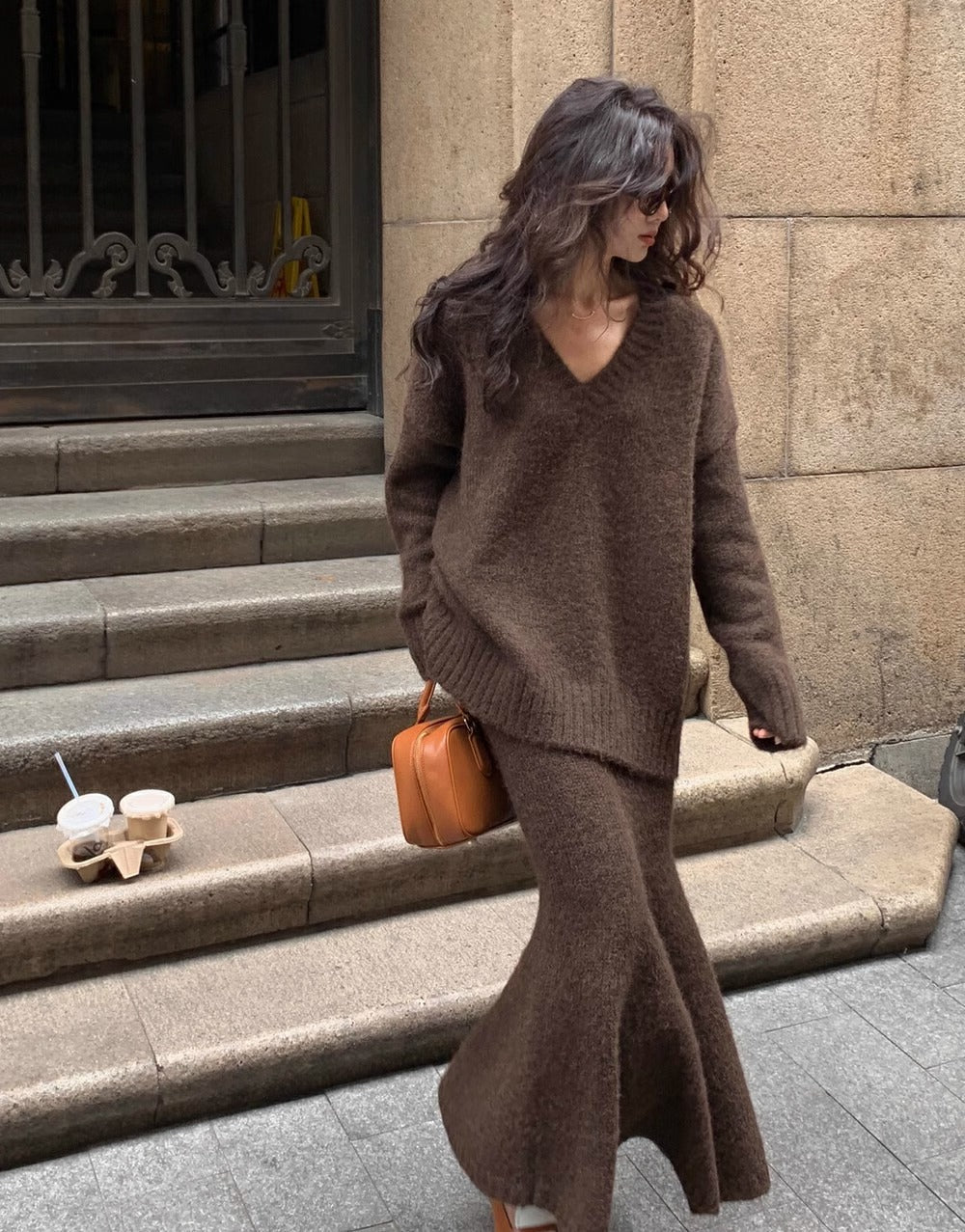 Women's elegant brown V-neck sweater and midi skirt set, long sleeve two-piece outfit for versatile fashion.