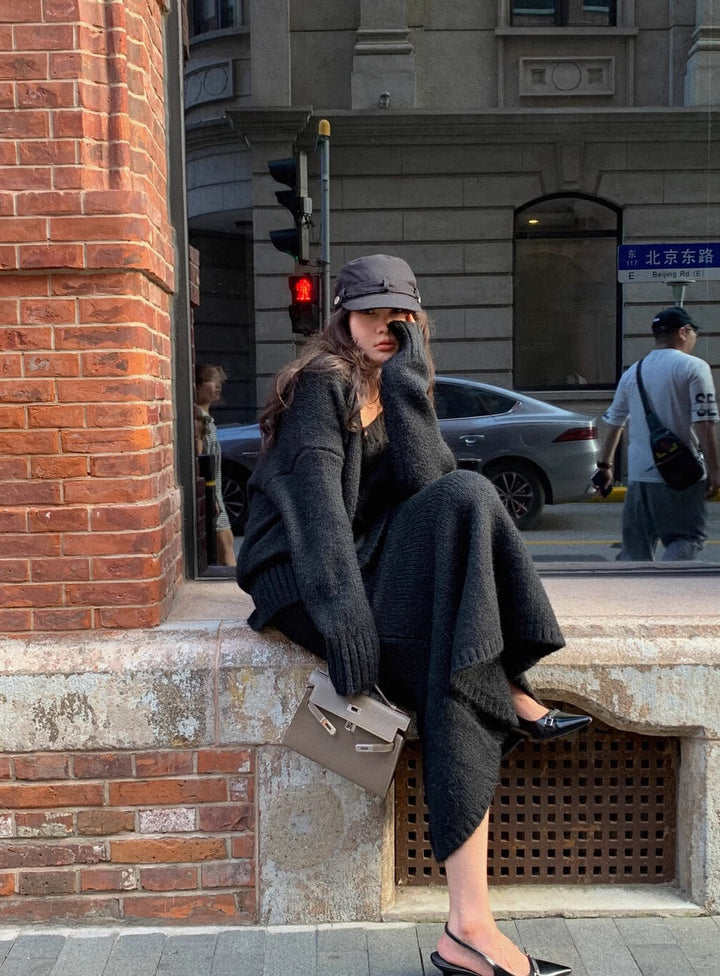 Elegant women's two-piece V-neck long sleeve sweater and midi skirt set in a sophisticated gray tone.