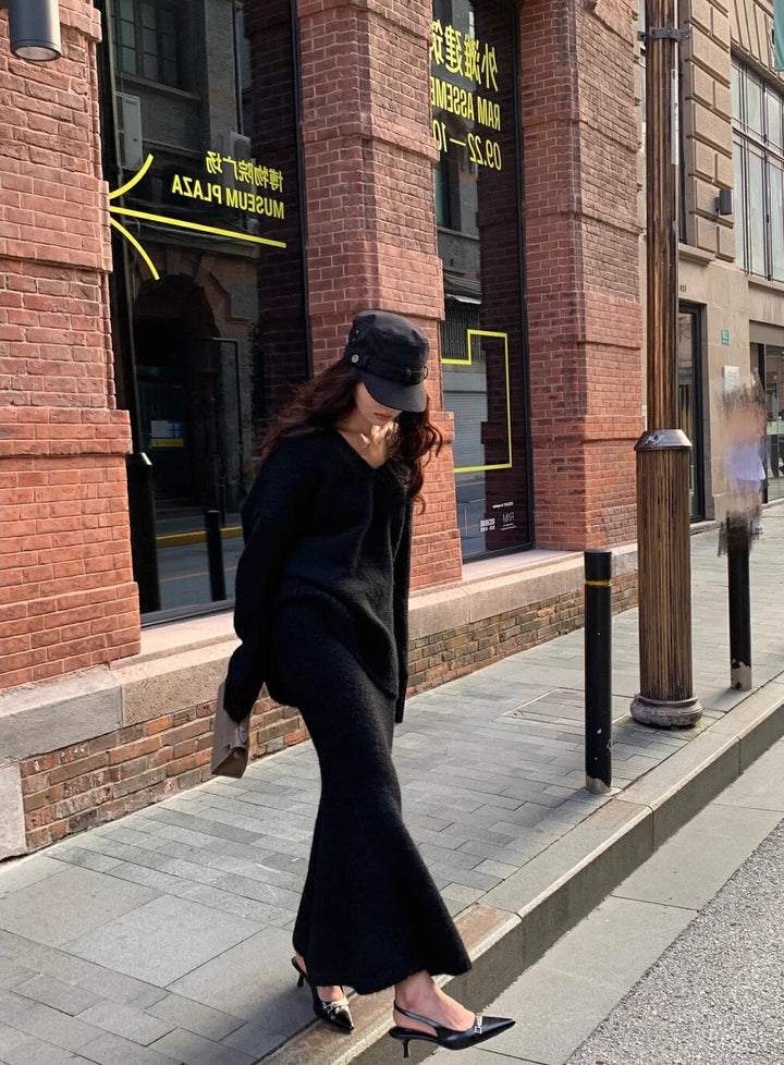 Women's elegant black V-neck long sleeve sweater and midi skirt set, a versatile two-piece for casual elegance.