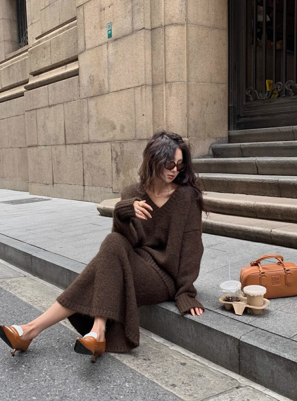 Casual elegant women's V-neck long sleeve sweater and midi skirt set in brown, a versatile two-piece outfit.