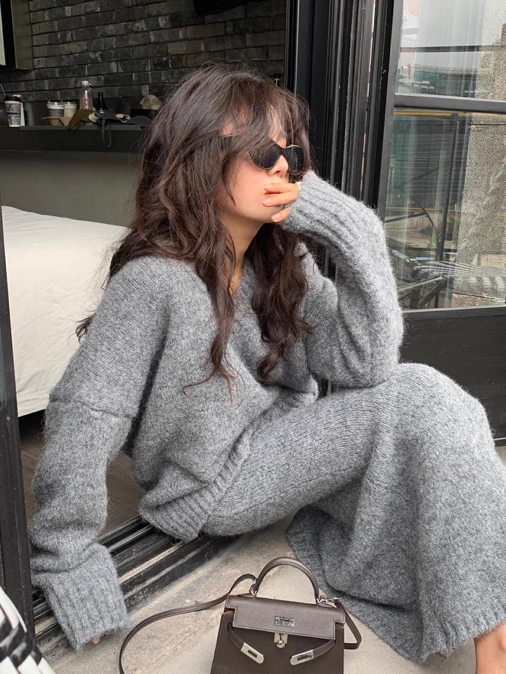 Chic gray V-neck long sleeve sweater and midi skirt set, an elegant two-piece women's brunch outfit.