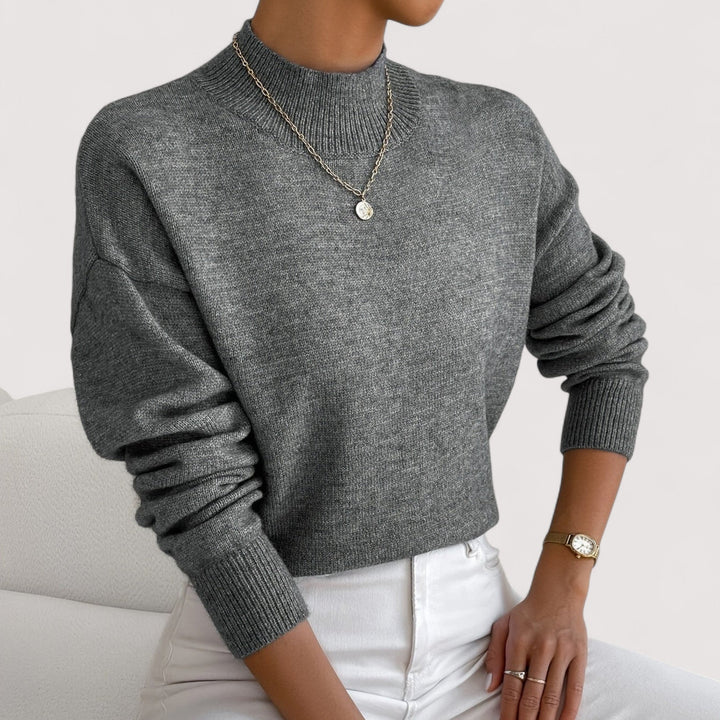 Women's warm long-sleeve turtleneck sweater, an elegant solid color knit for cozy winter comfort.