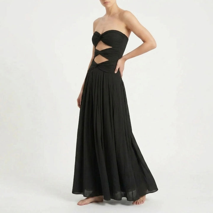 Elegant women's one-piece cutout monokini, paired with a breezy resort skirt. Vacation style.