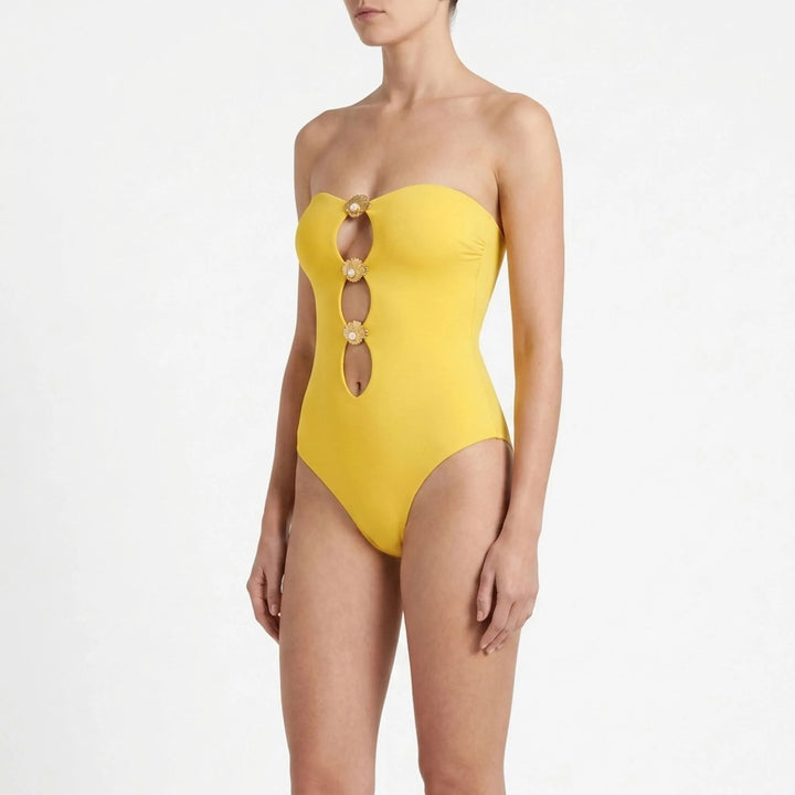 Stylish women's cutout swimsuit & beach cover-up skirt set for resort and vacation.