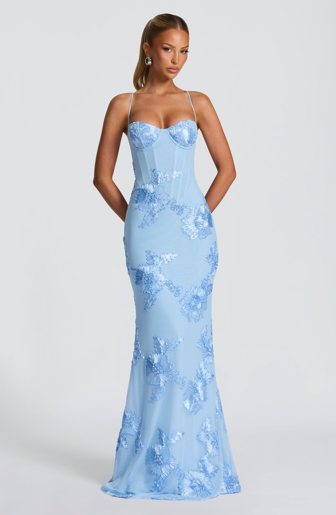 Sophisticated women's formal mermaid maxi dress with beautiful floral appliqué and structured corset. Wedding guest.