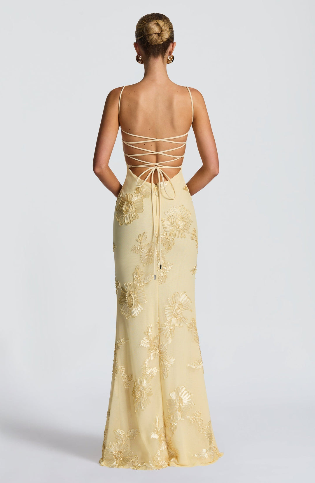 Close-up of intricate floral appliqué on a women's formal corset mermaid maxi dress, perfect for weddings.