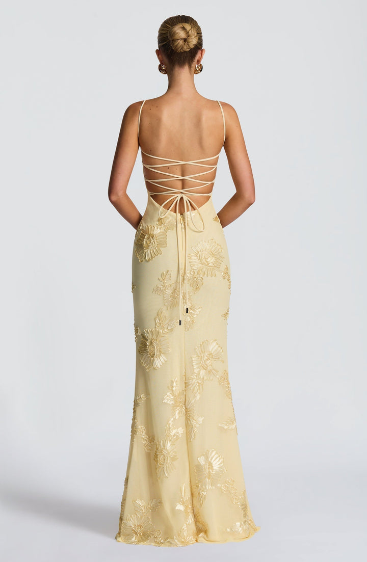 Close-up of intricate floral appliqué on a women's formal corset mermaid maxi dress, perfect for weddings.