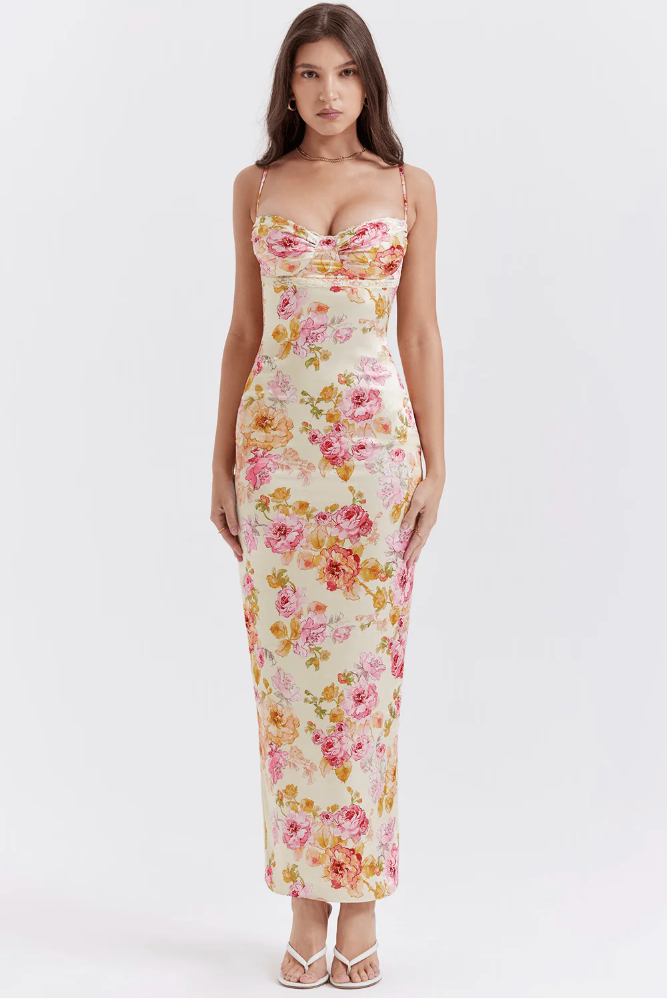 Flowy floral maxi slip dress featuring a structured corset top, designed for elegant wedding guest wear.