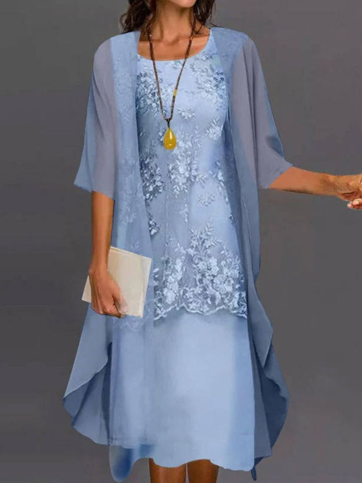Women's elegant floral embroidered midi dress with asymmetrical hem & three-quarter sleeves, perfect for summer vacation.