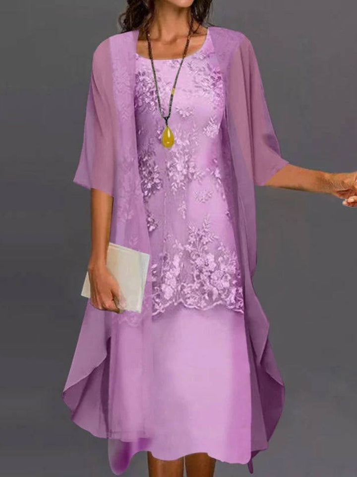 Beautiful women's floral embroidered dress with a flowing asymmetrical hem & three-quarter sleeves, ideal for summer.