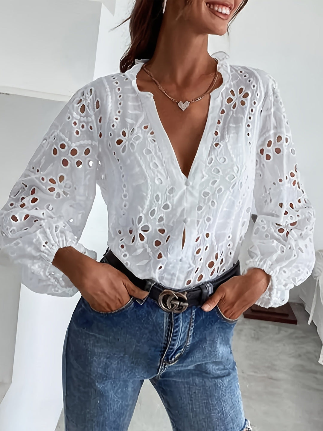Versatile women's floral embroidered blouse with long sleeves and button front, ideal for elegant spring outfits.
