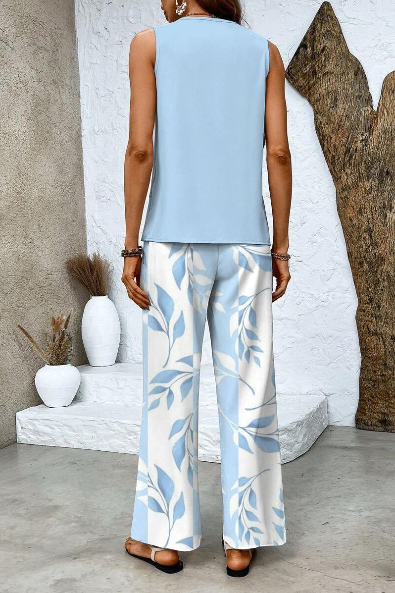 Stylish women's floral print top. Versatile and elegant, part of a chic two-piece trouser set.