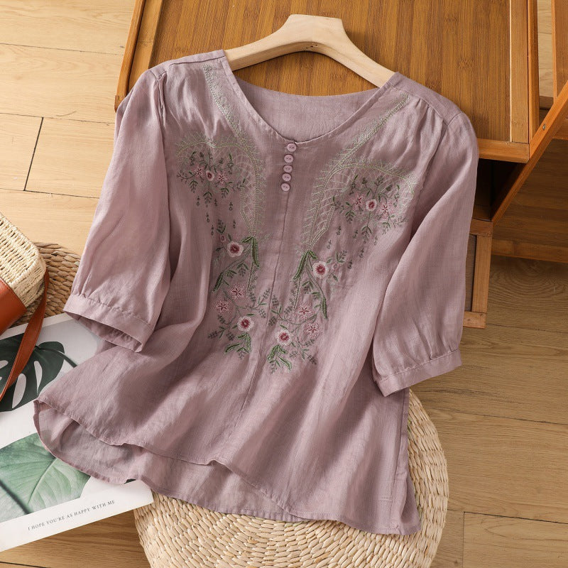 Close-up of a women's relaxed fit floral blouse featuring intricate embroidery, V-neck, and flowing long sleeves.