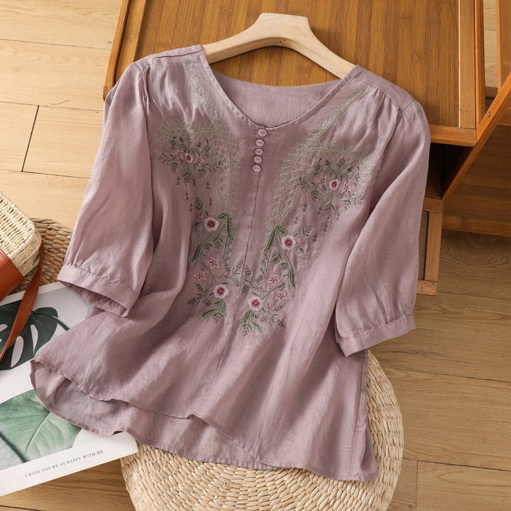 Close-up of a women's relaxed fit floral blouse featuring intricate embroidery, V-neck, and flowing long sleeves.