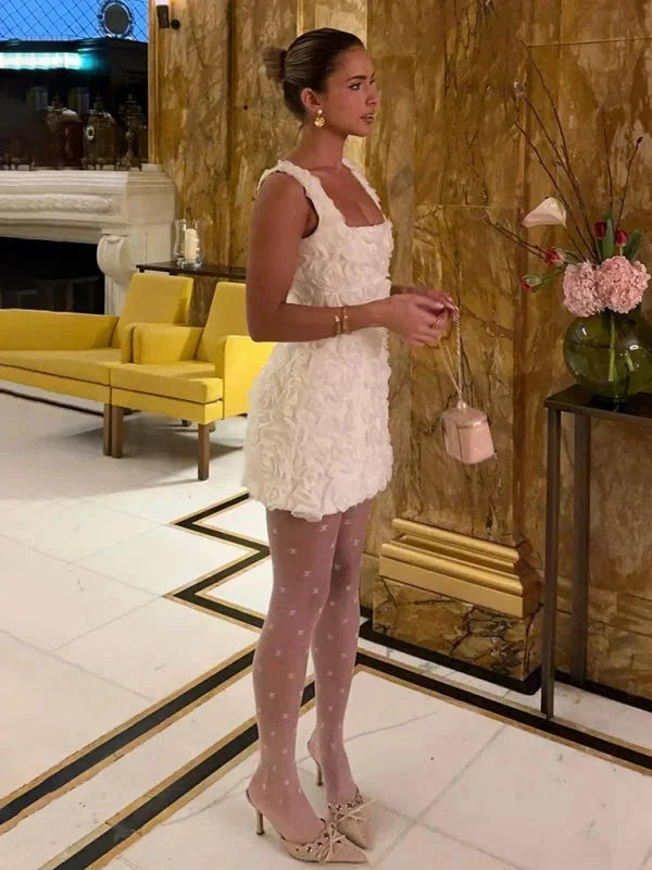 Elegant women's mini dress with floral texture, a chic choice for parties.