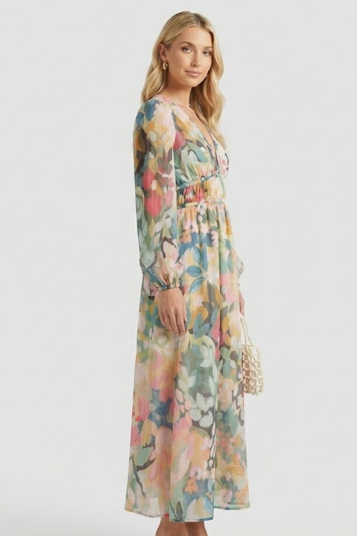 Feminine women's V-neck maxi dress with long sleeves, vibrant floral print, flowy fit.