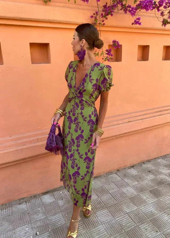 Stylish women's floral midi dress featuring a flattering wrap V-neckline and trendy puff sleeves. Great for summer.