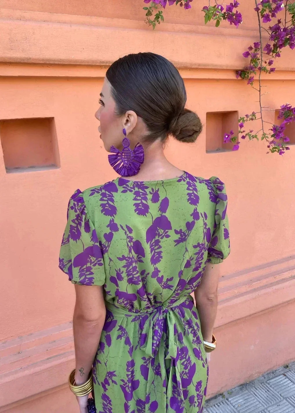 Full view of a women's green floral midi dress, showcasing its wrap V-neck, puff sleeves, and flowy silhouette.