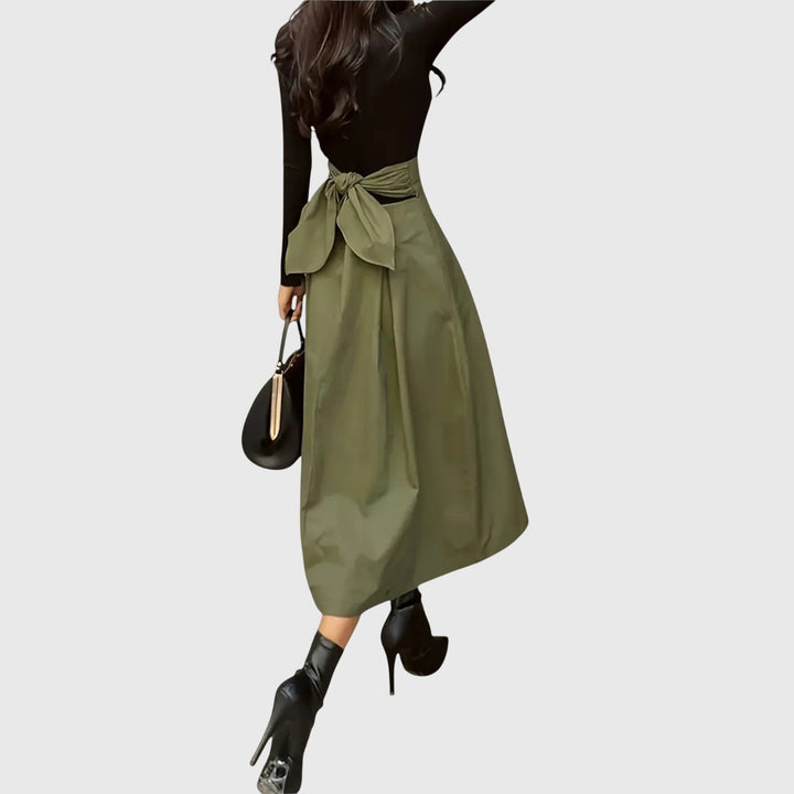 Versatile women's green pleated midi skirt with a high waist, ideal for elegant casual chic outfits.