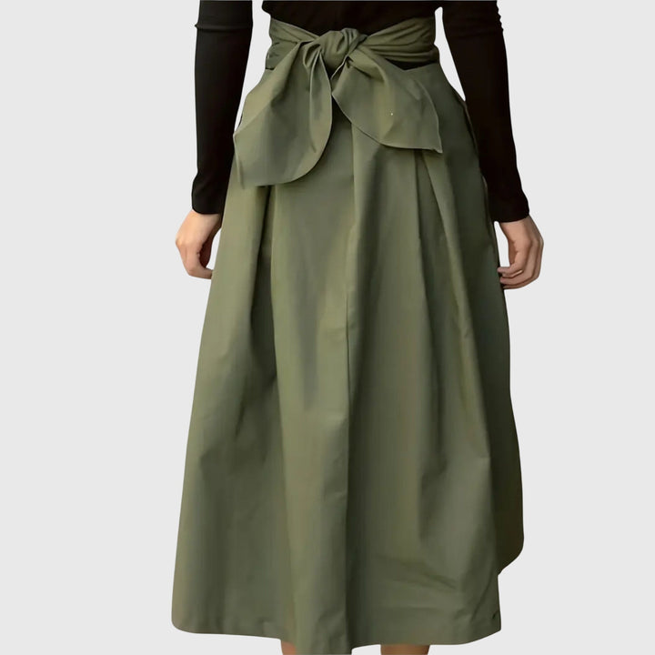 Stylish women's green high-waist pleated midi skirt, offering an elegant look for spring or office.
