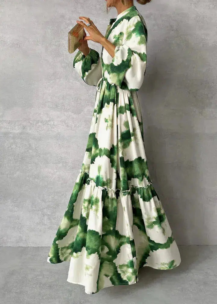 White women's formal maxi dress featuring elegant puff sleeves, V-neck, and tiered skirt, perfect for parties.