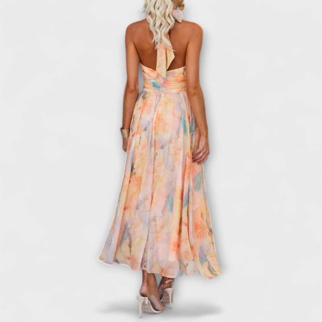 Chic women's halter maxi dress featuring an open back, flowy silhouette, ideal for elegant summer parties.