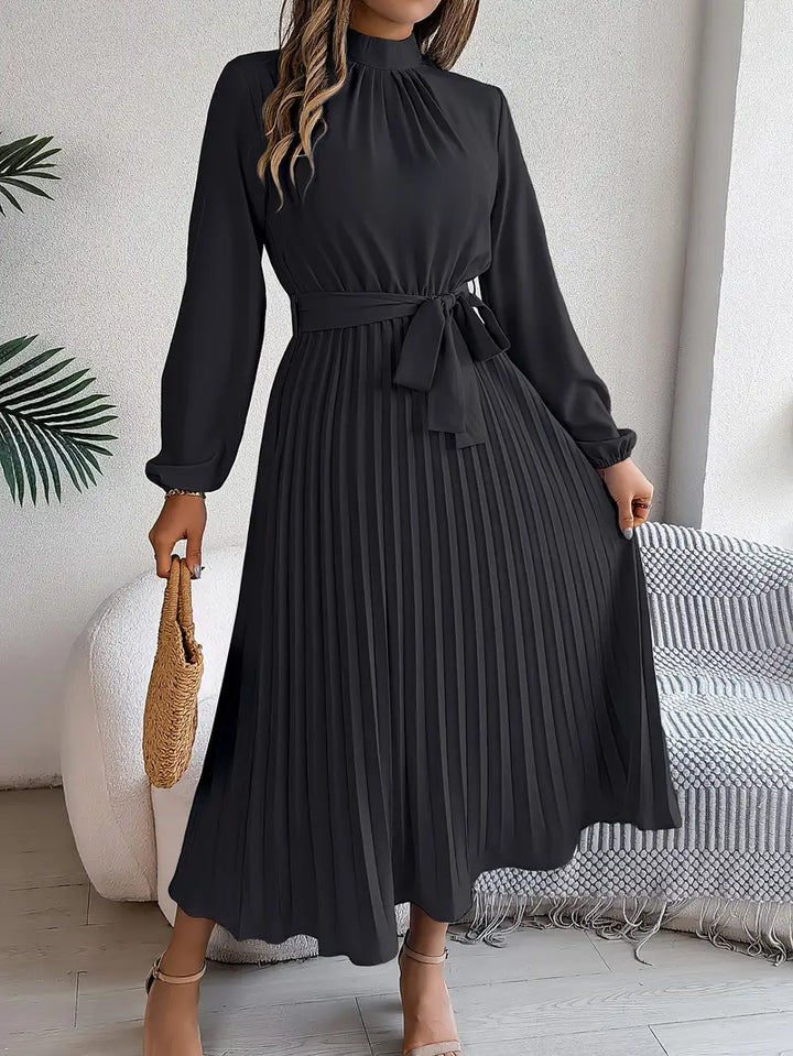 Modern women's long sleeve pleated midi dress, belted for a sleek silhouette. Perfect for spring/fall style.