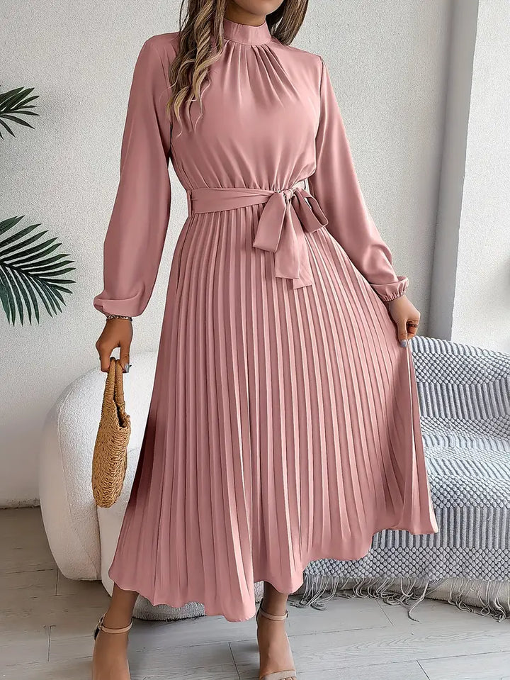 Women's long sleeve midi dress featuring delicate pleats & a flattering belt. Chic, versatile, and stylish.