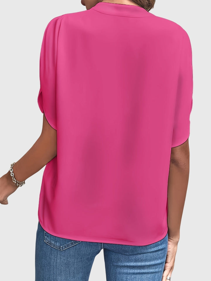 Detail shot: elegant women's blouse fabric, highlighting quality and chic design.