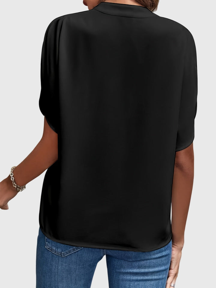 Elegant women's blouse with a classic cut, perfect for professional or social gatherings.