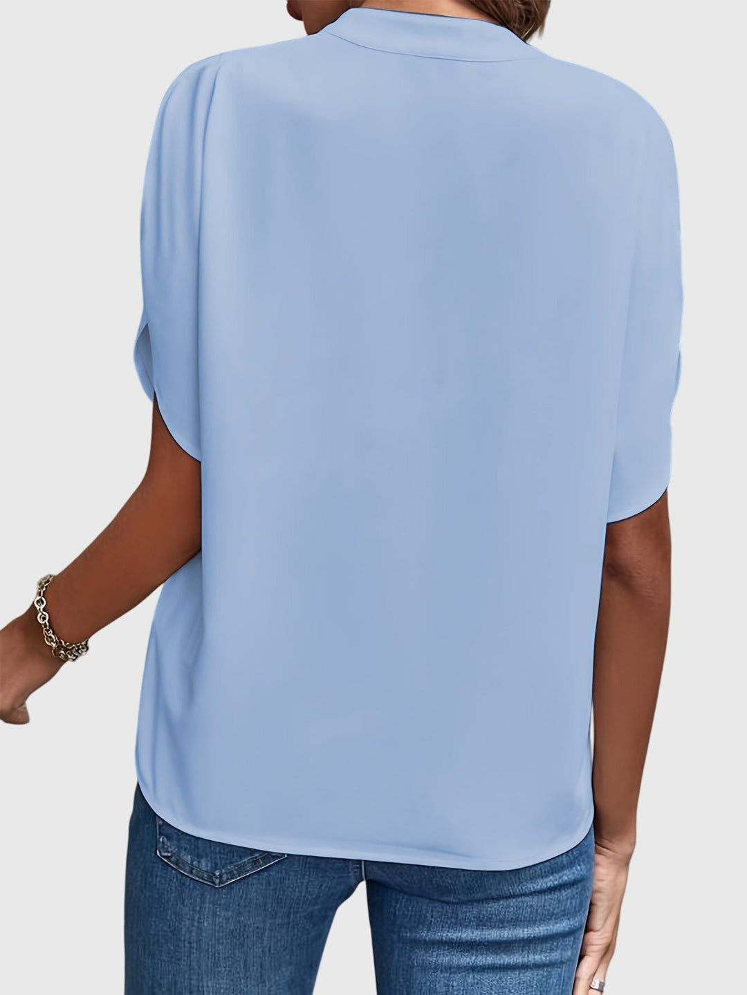 Stylish long-sleeve women's top, versatile for a polished office look or casual chic.