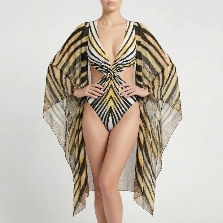 Women's long-sleeve monokini, elegant cutout one-piece, abstract print, resort-ready beachwear.