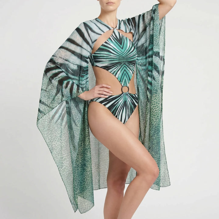 Modern long-sleeve monokini for women, elegant cutout swimsuit, abstract print for sun protection.