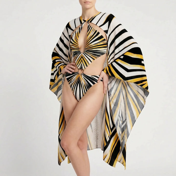 Unique long-sleeve one-piece monokini with abstract print, elegant cutouts, and flared sleeves.
