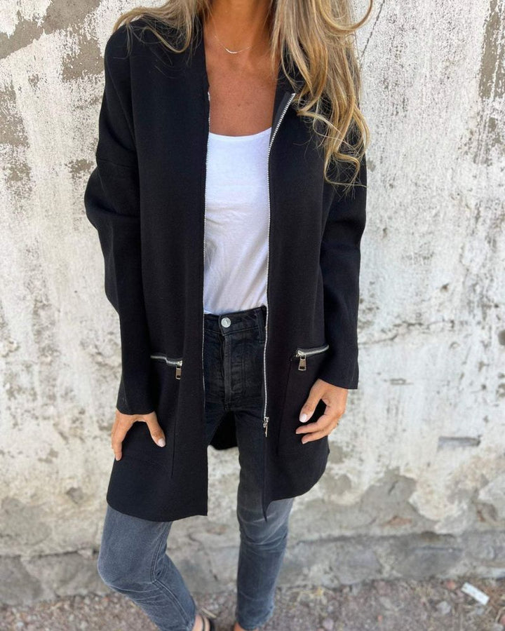Close-up of an elegant women's knit cardigan with a stylish front zipper and long sleeves.