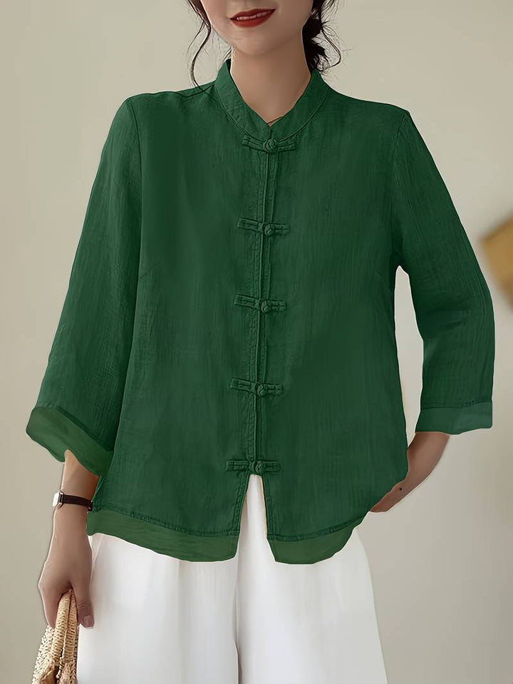 Women's elegant mandarin collar blouse with frog buttons, perfect for office or casual wear.