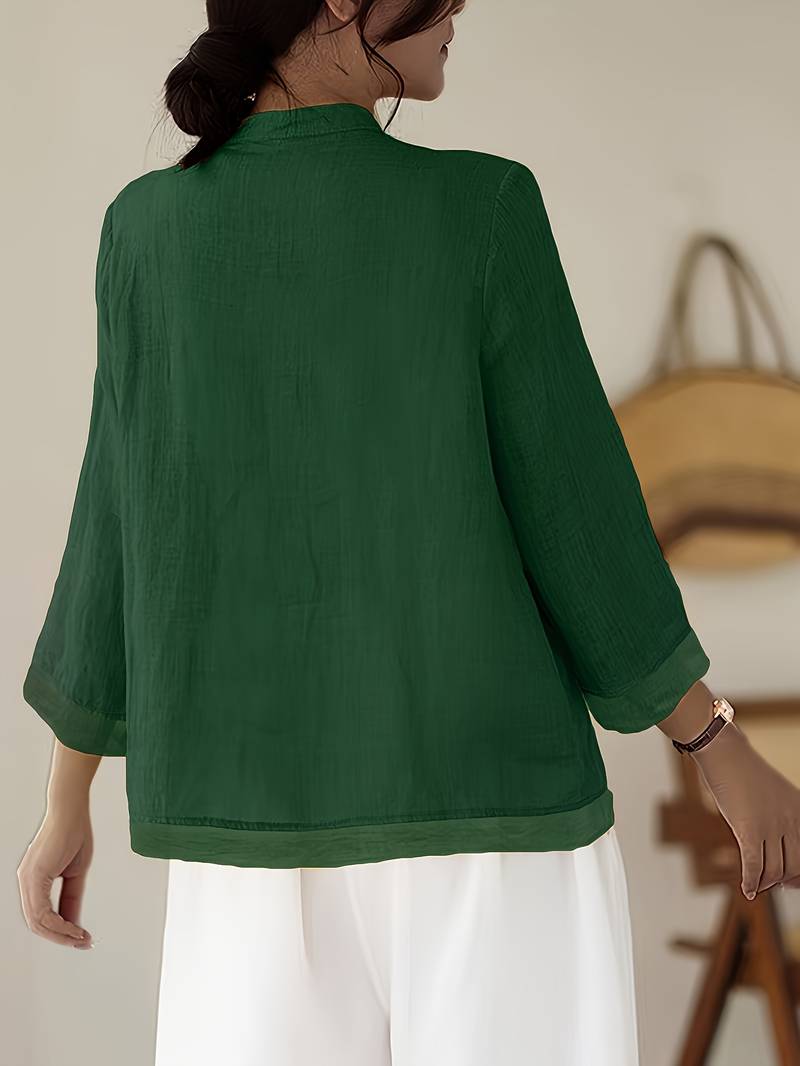 Back view of a women's three-quarter sleeve mandarin collar blouse with tailored fit.