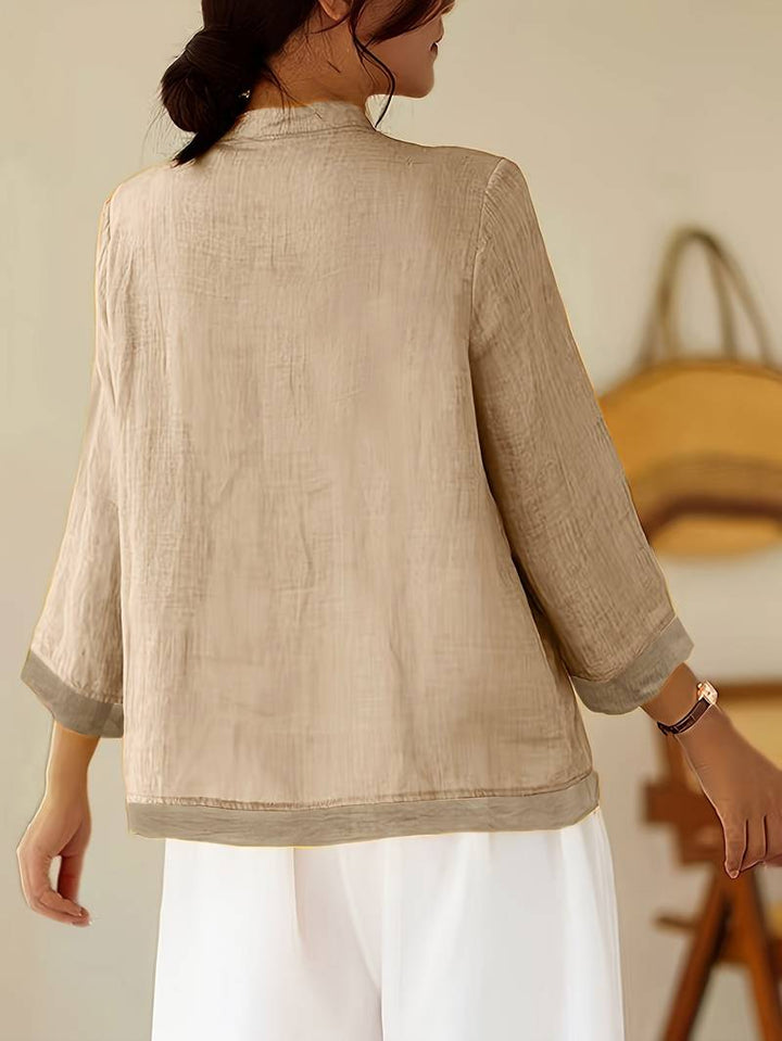 Fashionable women's frog button blouse, mandarin collar, and tailored fit for chic office wear.