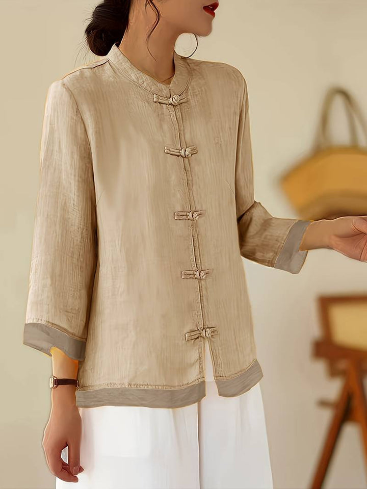 Comfortable and stylish women's casual blouse with mandarin collar and unique frog button detail.