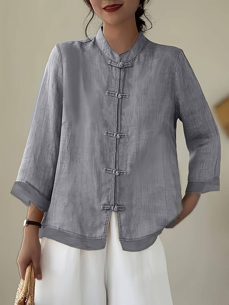 Tailored fit women's three-quarter sleeve blouse with elegant mandarin collar and frog buttons.