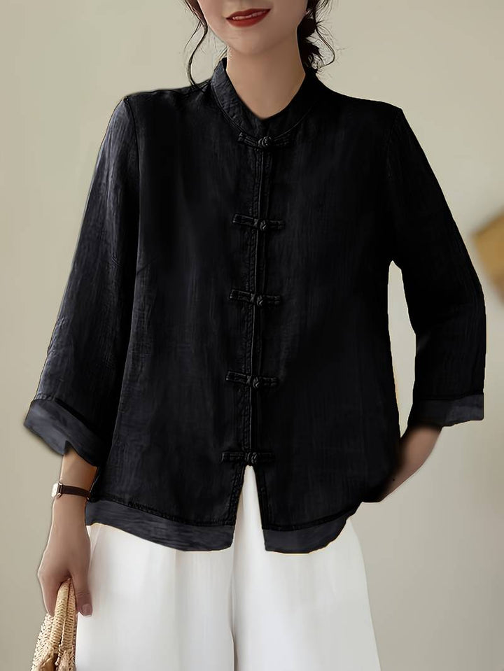 Model wearing a tailored women's mandarin collar blouse, suitable for elegant office wear.