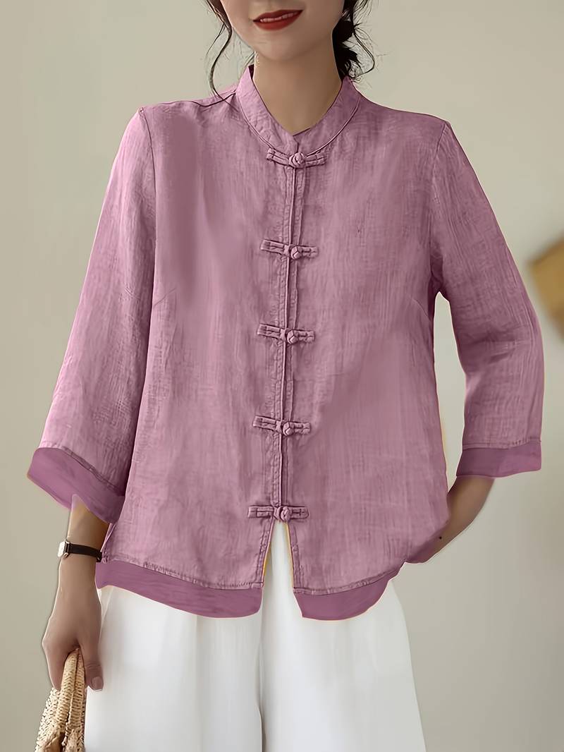 Front view of a women's three-quarter sleeve blouse, mandarin collar & frog buttons.